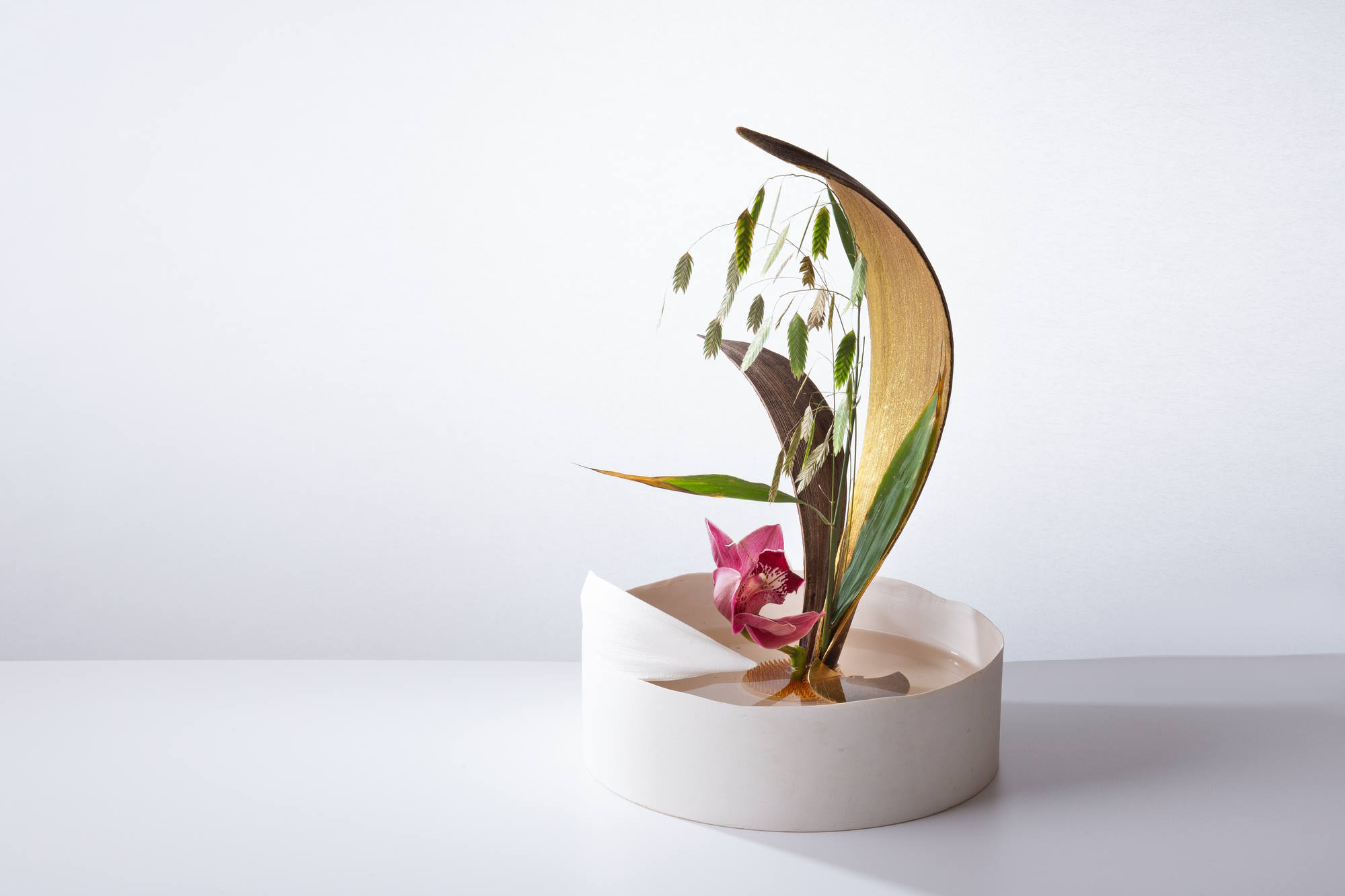 Mirit Weinstock, Never is a long time, 2024. Porcelain, dry palm, Wild oats, gold lacquer, brass, 24 Karat gold, orchid. Photo: Yoshiyuki  Sano